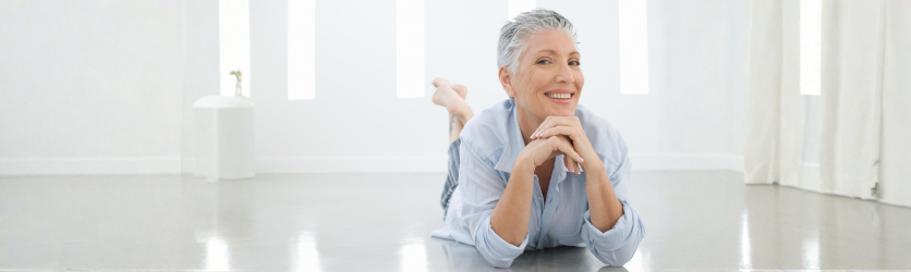 Mature woman practising calming yoga at home